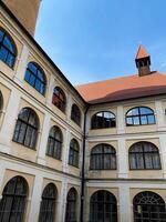 Historic building courtyard with arched windows and red roof in Veveri castle, Czech Republic. photo