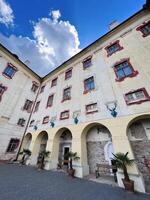 Majestic European building facade under a vibrant blue sky in Kunstat, Czech Republic. photo