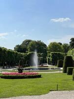 Beautiful park landscape with fountain and manicured green hedges in Schonbrunn palace, Austria. photo