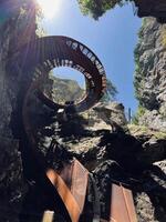 Spiral staircase in a rocky canyon with sunlight streaming through in Liechtensteinklamm, Austria photo