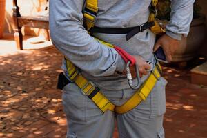 Man wearing a yellow safety harness photo