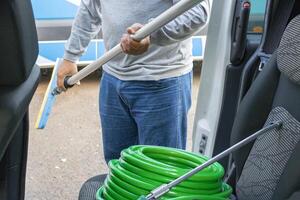 Cleaner manwith your tools. Conceptual image of car washing job. photo