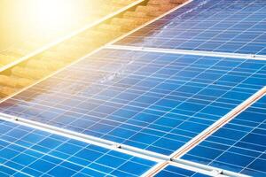 Solar worker cleaning photovoltaic panels with brush and water. Photovoltaic cleaning, before and after concept image. Space for text. photo