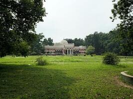 A large building in the middle of a field photo