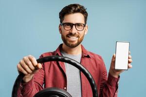 Smiling, handsome bearded Hispanic man wearing eyeglasses, holding mobile phone with empty screen photo