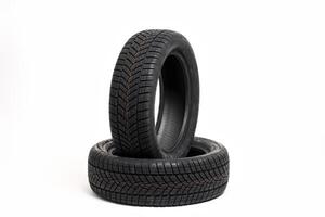 Two new winter tires standing on white background photo
