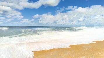 A beach with waves and clouds in the sky photo