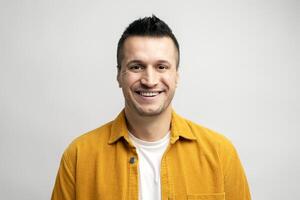 Cheerful man smiling and showing positive emotions on white background photo