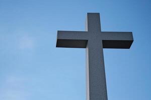 A Tall Cross Standing Majestically Against the Clear Blue Sky photo
