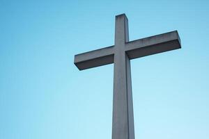 A Serene Concrete Cross Set Against a Clear Blue Sky photo