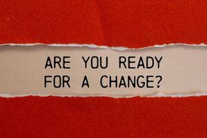 Are you ready for a change message written on ripped torn red paper with beige background. Conceptual are you ready for a change symbol. Copy space. photo