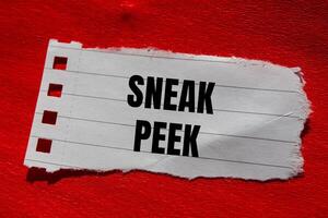 Sneak peek message written on ripped torn paper piece with red background. Conceptual sneak peek symbol. Copy space. photo