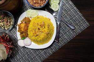 Egg khichuri rice with fried onion served in plated isolated on background side view of Bangladeshi food photo