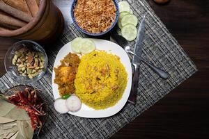 Egg khichuri rice with fried onion served in plated isolated on background side view of Bangladeshi food photo