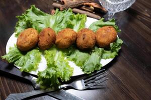 mashed potatoes with chicken cutlets and greens on a dark background top view photo
