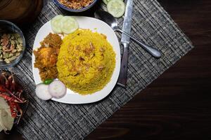 Egg khichuri rice with fried onion served in plated isolated on background side view of Bangladeshi food photo