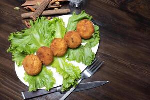 mashed potatoes with chicken cutlets and greens on a dark background top view photo