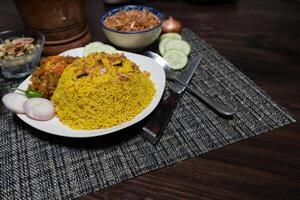 Egg khichuri rice with fried onion served in plated isolated on background side view of Bangladeshi food photo