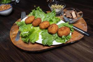 mashed potatoes with chicken cutlets and greens on a dark background top view photo