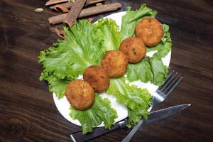 mashed potatoes with chicken cutlets and greens on a dark background top view photo