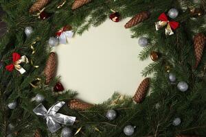 Christmas decorations on snow with fir tree branches and Christmas lights. New Year Background with copy space for text. photo