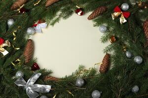 Christmas decorations on snow with fir tree branches and Christmas lights. New Year Background with copy space for text. photo