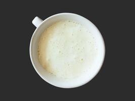 Milk Foam Coffee in the Cup isolated on black background photo
