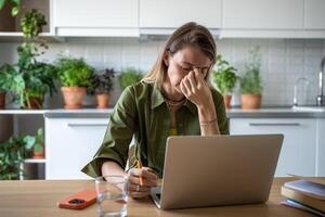 Stressed woman feeling exhausted of overtime work, realizing failure to keep to task deadline photo