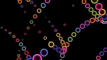 Trails of colored balls on a black background in a seamless loop. video