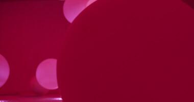 Red balloons float against a red background, creating a vibrant and festive atmosphere perfect for celebrations video