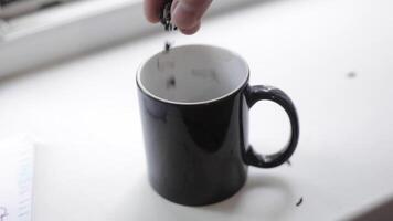 A man pours tea into a mug. video