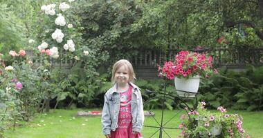 Girl child having fun in the rain. a little girl running around having fun in the rain in the yard at home video