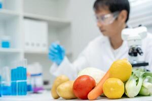 Scientist check chemical food residues in laboratory. Control experts inspect quality of fruits, vegetables. lab, hazards, ROHs, find prohibited substances, contaminate, Microscope, Microbiologist photo
