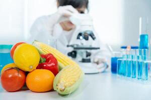 Scientist check chemical food residues in laboratory. Control experts inspect quality of fruits, vegetables. lab, hazards, ROHs, find prohibited substances, contaminate, Microscope, Microbiologist photo