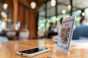 smartphone to scan QR code for order menu in cafe restaurant with a digital delivery. Choose menu and order accumulate discount. E wallet, technology, pay online, credit card, bank app. photo