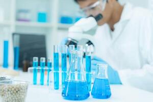 Scientist analyze biochemical samples in advanced scientific laboratory. Medical professional use microscope look microbiological developmental of viral. Biotechnology research in science lab. photo
