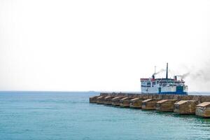 Ocean Giant by the Coast. Capturing Beauty on a Sunny Day. Large passenger ferry boat sailing the ocean. photo
