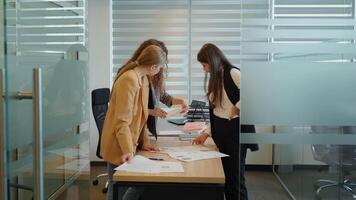Team of three best workers brainstorming strategy for new release in office. video