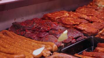 Diverse range of sausages and meat prepared to be cooked. video