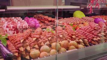 Display window butchers shop with meat arrangment either for grill or barbeque. video