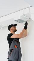 HVAC Technician Worker Testing Newly Installed Office Ventilation System. Vertical video