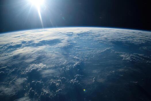 Earth from space with sun shining on horizon. photo