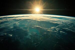 Sunrise over Earth from space, with a sunburst. photo