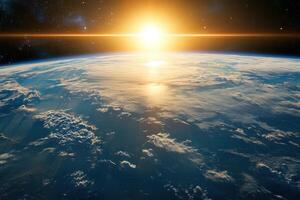 Sunrise over Earth from space, with clouds and a bright sun. photo