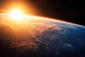 Sunrise over Earth from space, showing clouds and a bright sun. photo