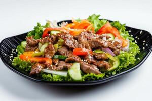 Beef and vegetable salad with sesame seeds. photo