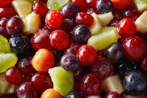 A close-up of a colorful fruit salad with grapes, cherries, kiwi, and cranberries. photo