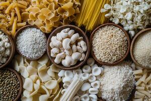 An assortment of different types of pasta and grains in wooden bowls. photo