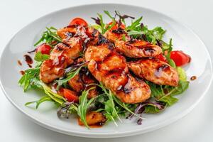 Grilled salmon and cherry tomato salad with balsamic glaze. photo