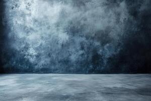 A dark blue concrete wall with a spotlight shining on the floor. photo
